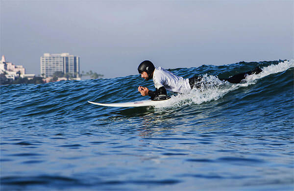 World champion quadriplegic surfer Jesse Billauer surfing on a surfing board in sea