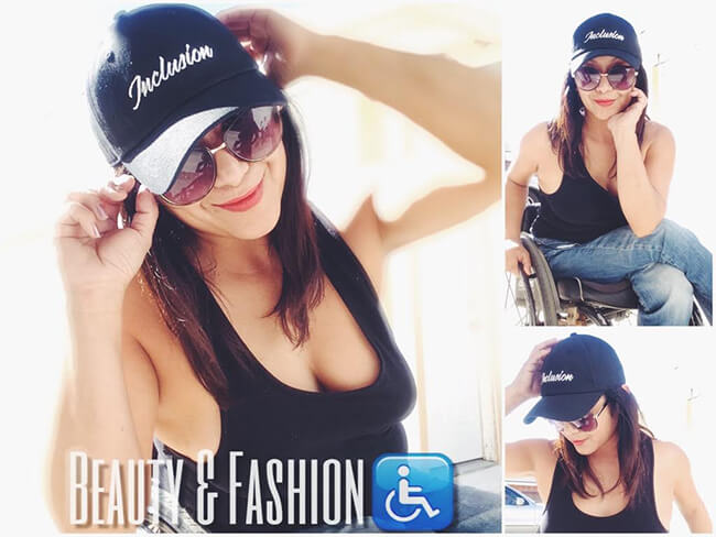 A women sitting on a wheelchair wearing an inclusion cap and smiling