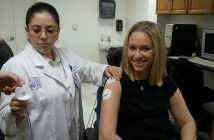 A women sitting on a chair smiling and getting a biofeedback