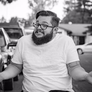 A man on a wheelchair acting out a funny pose