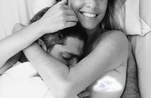 A man and woman laying in bed