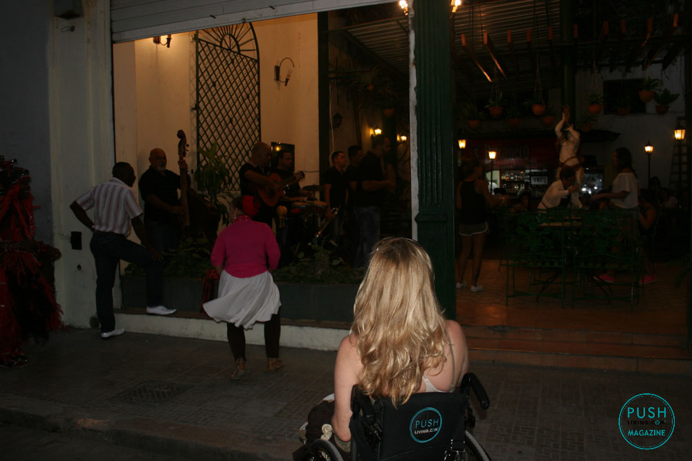 woman in wheelchair watching people dancing