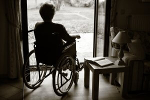 wheelchair 300x200 - woman on a wheelchair looking outside