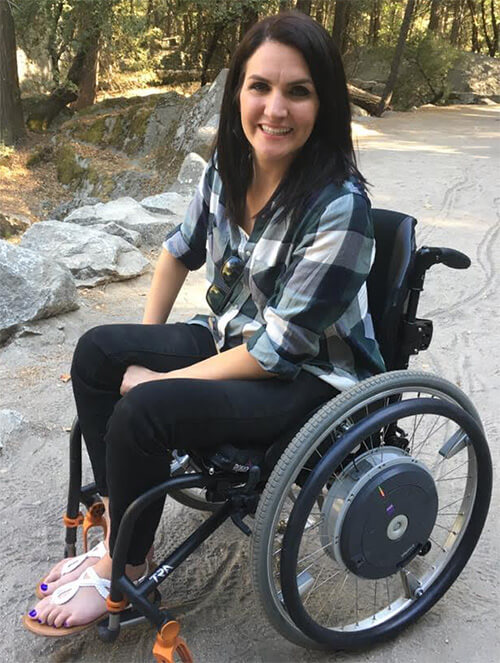 a beautiful disabled women sitting on her wheelchair and smiling