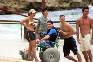 man on wheelchair enjoying beach with friends 300x200 - man on wheelchair enjoying beach with friends