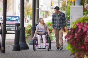 woman on a wheelchair talking to a man