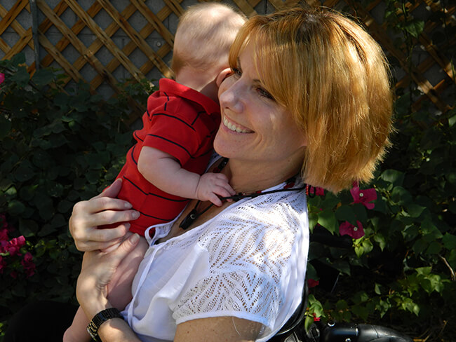 A women holding a baby and smiling