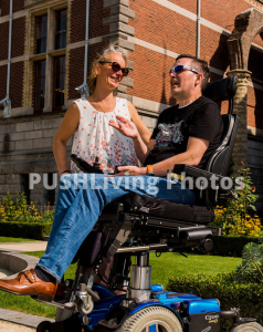 Couple using power wheelchairs talking in a museum garden 238x300 - Couple using power wheelchairs talking in a museum garden