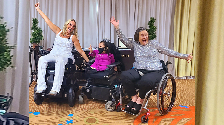 three ladies on wheelchairs posing at an event
